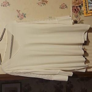 White top with crochet on the arms and bell sleeves